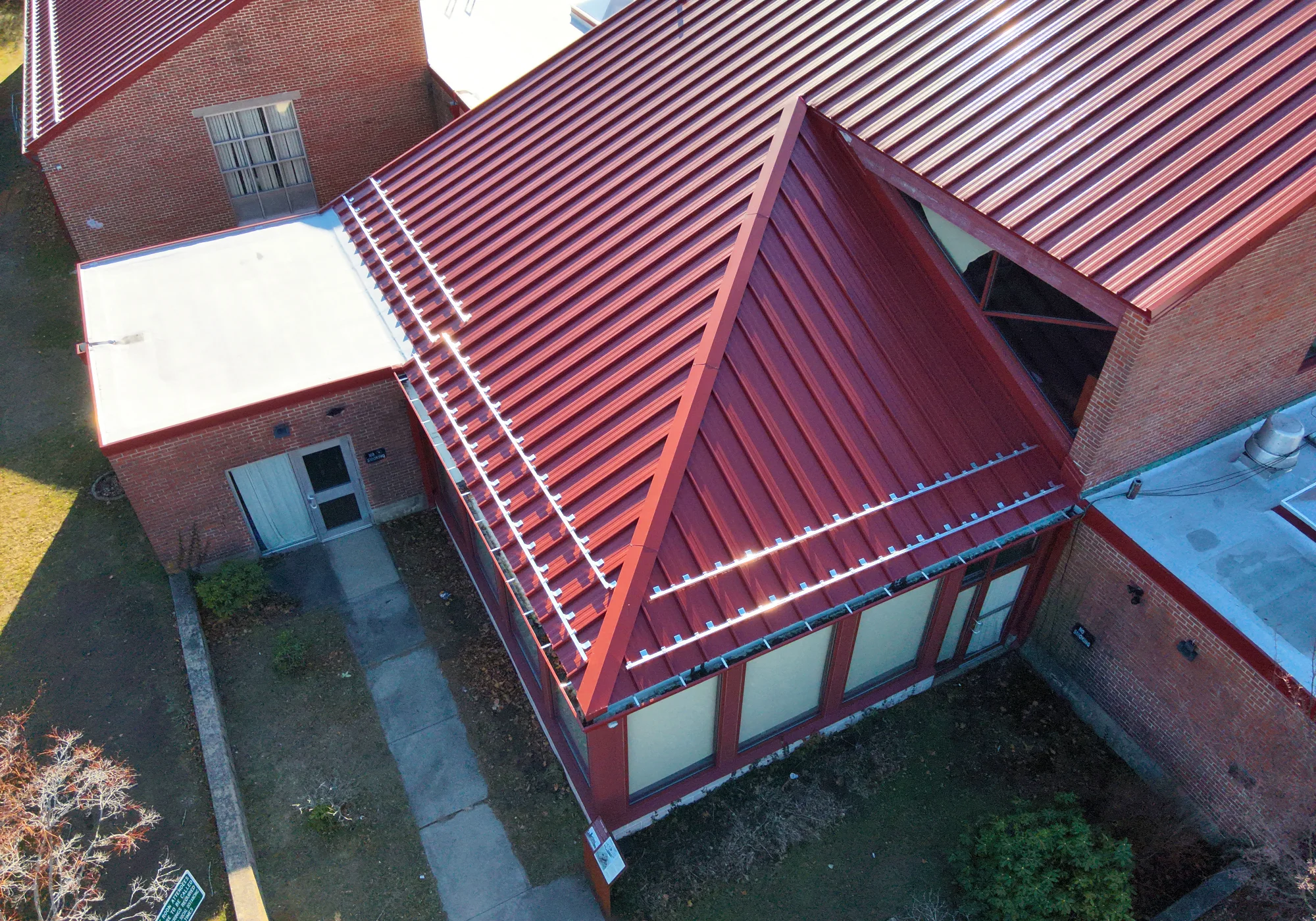 Drone photograph of a metal roof with snow guards on Woonsocket Harris Library