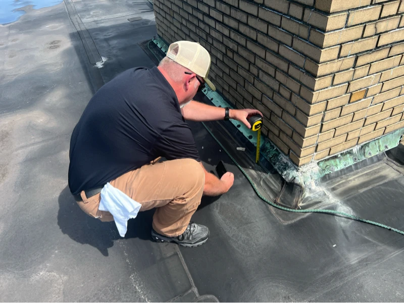 Greenwood Industries employee inspecting a roof